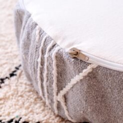 Close-up of zipper opening on the grey side panel of a cotton pouf