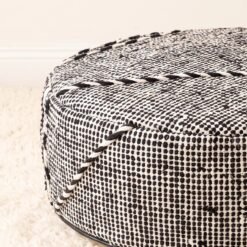 Close-up of black white grid cotton pouf showing woven texture and raised decorative lines