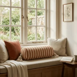 Brown striped bolster pillow cover on window seat