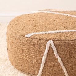 Close-up of camel cotton pouf with raised ivory lines and curved seam