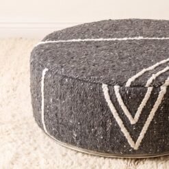 Close-up of charcoal grey chevron cotton pouf showing woven texture and raised decorative lines