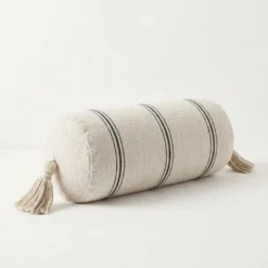 Cream and black striped cylindrical bolster pillow cover with tassels