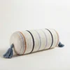 Cream multi stripe cylindrical bolster pillow cover with blue tassels on white background