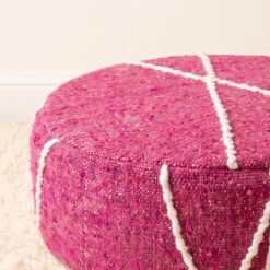 Close-up of fuchsia pink striped cotton pouf showing woven texture and raised decorative lines