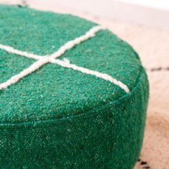 Close-up of green cotton pouf with raised ivory cross lines