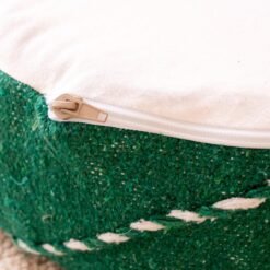 Close-up of zipper opening and white inner lining on a green cotton pouf