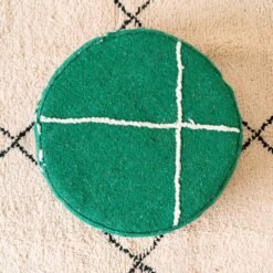 Overhead view of green round cotton pouf with ivory cross lines