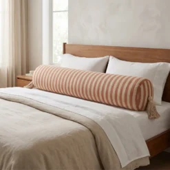 Extra long brown striped bolster pillow cover across bed