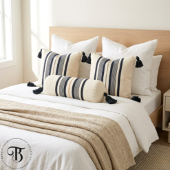 Black stripe Moroccan bolster pillow styled on a neutral bedroom bed