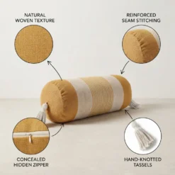 Mustard and ivory striped bolster pillow showing natural woven texture, reinforced seams, concealed zipper and tassels