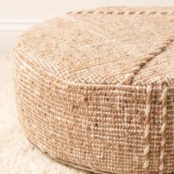 Close-up of natural beige cotton pouf showing textured weave and raised seam