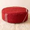 Red round cotton pouf with contrasting ivory stripes on the top and sides