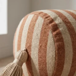 Brown and cream striped bolster pillow cover with tassel detail